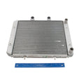 Rectangular metal radiator core with horizontal cooling fins and four mounting tabs, silver-gray finish, shown with blue.