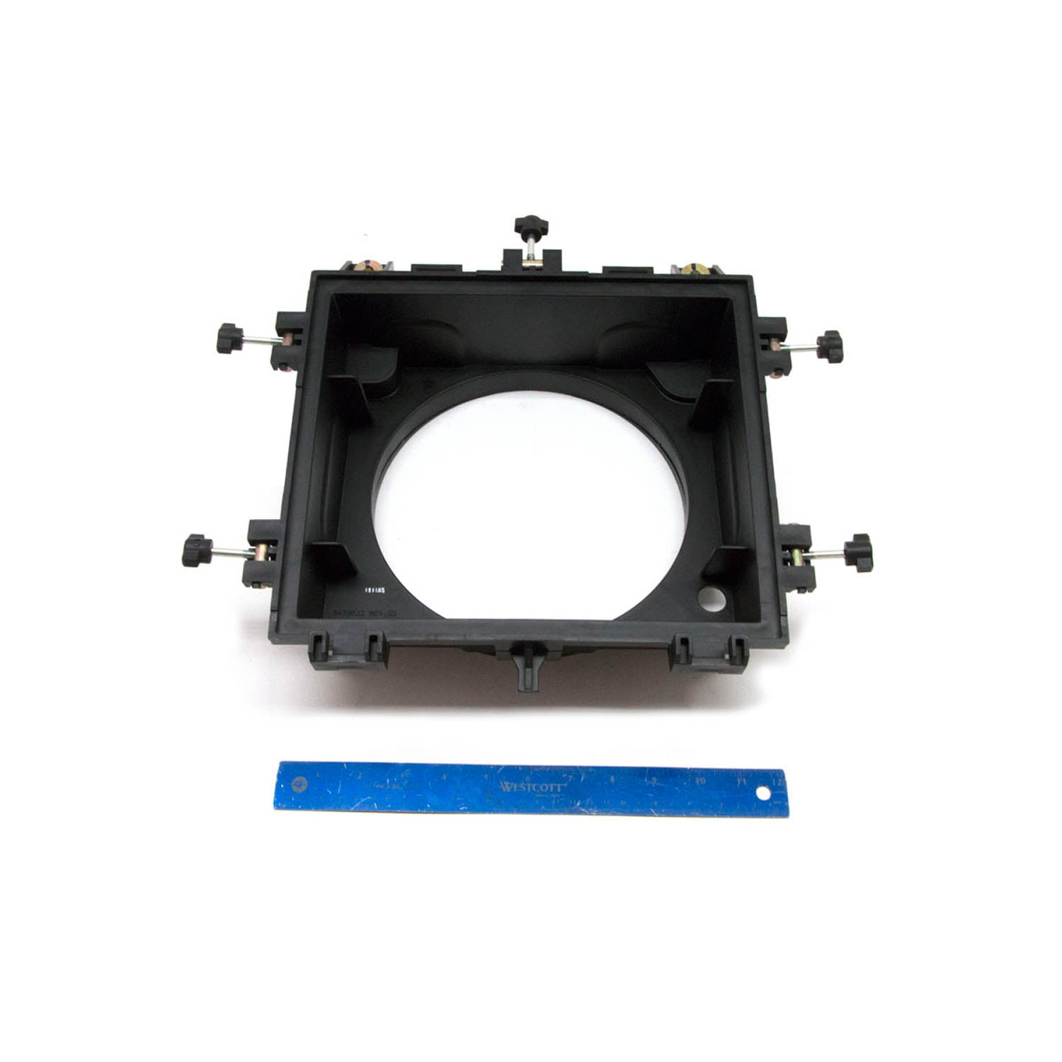 Black rectangular plastic air intake housing with circular center opening and adjustable mounting knobs.