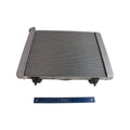 Rectangular metal Polaris radiator with horizontal cooling fins and black connectors, shown with blue ruler for scale.