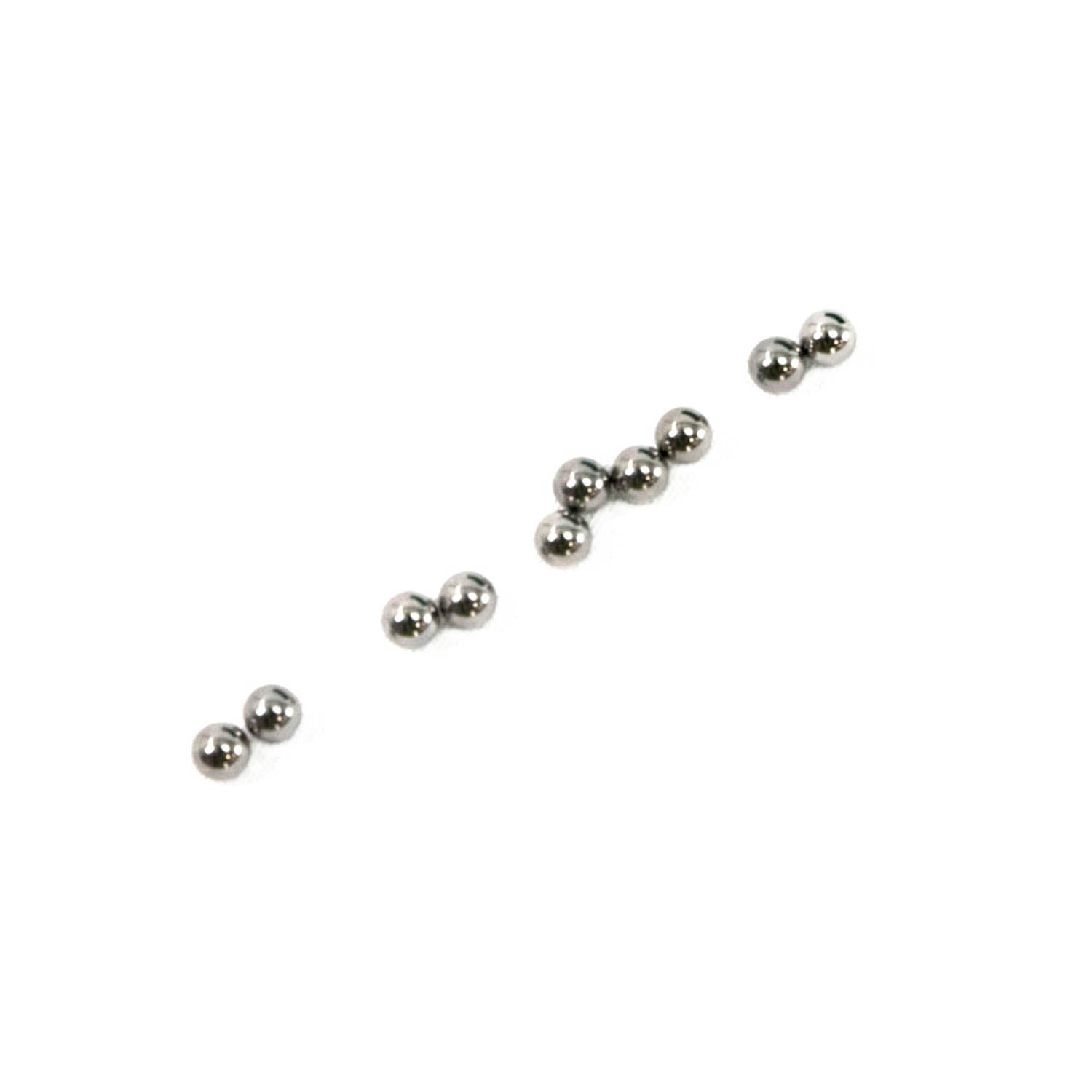 Set of small, shiny silver metallic ball bearings arranged on white background.