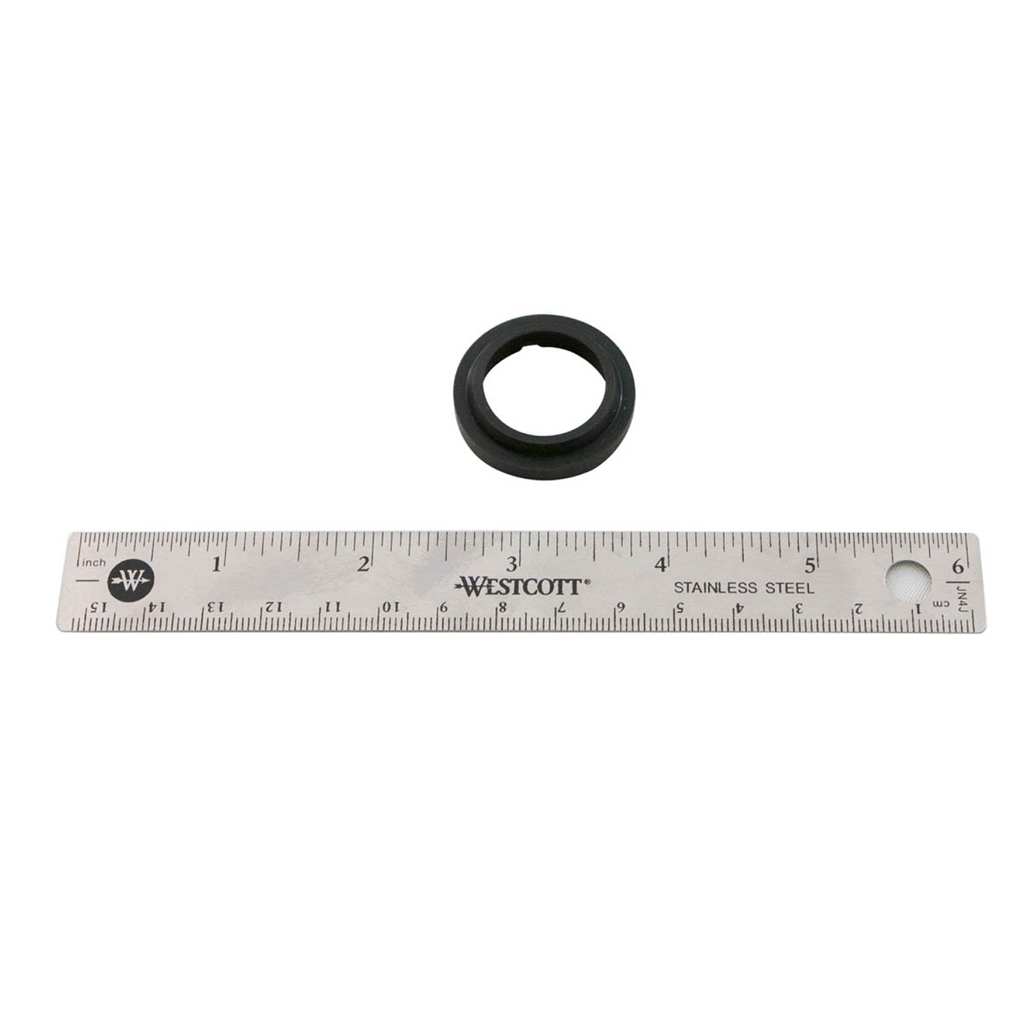 Black circular rubber wiper seal with .875-inch shaft diameter next to stainless steel ruler.