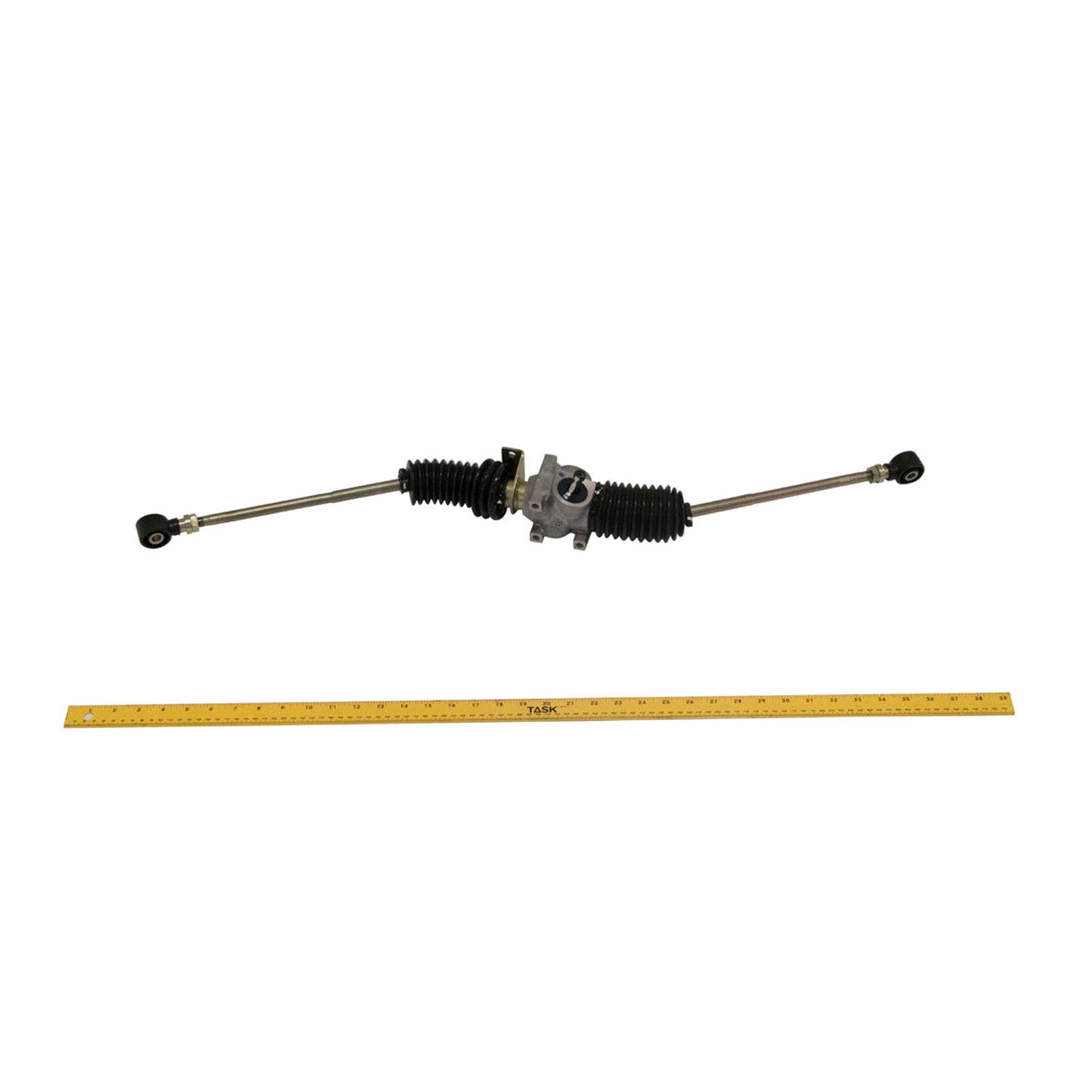 Metal steering gear box with rubber accordion boots on both ends and mounting bracket, shown with a measuring stick beneath.