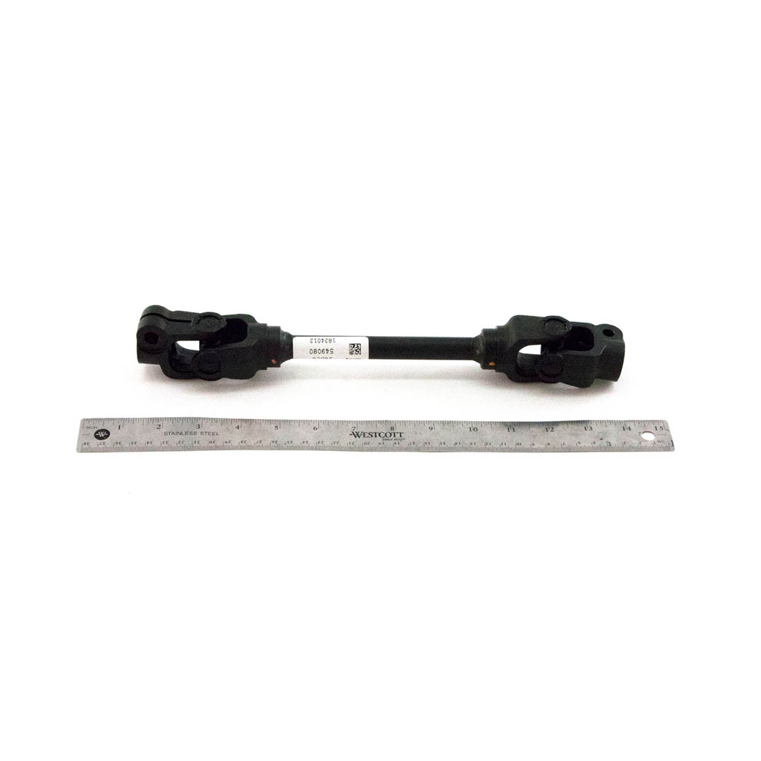 Black metal lower EPS steering shaft with U-joints on both ends, shown next to a 12-inch ruler for scale.