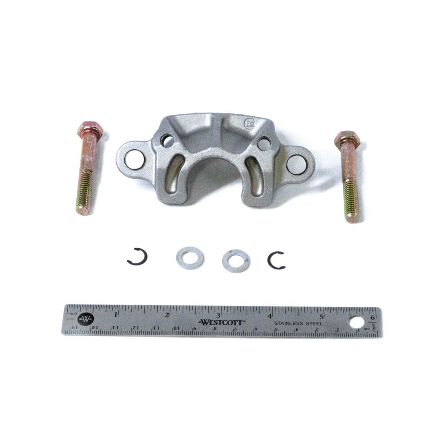 Silver metal ATV anvil body kit bracket with two bolts and small washers next to a 6-inch ruler.