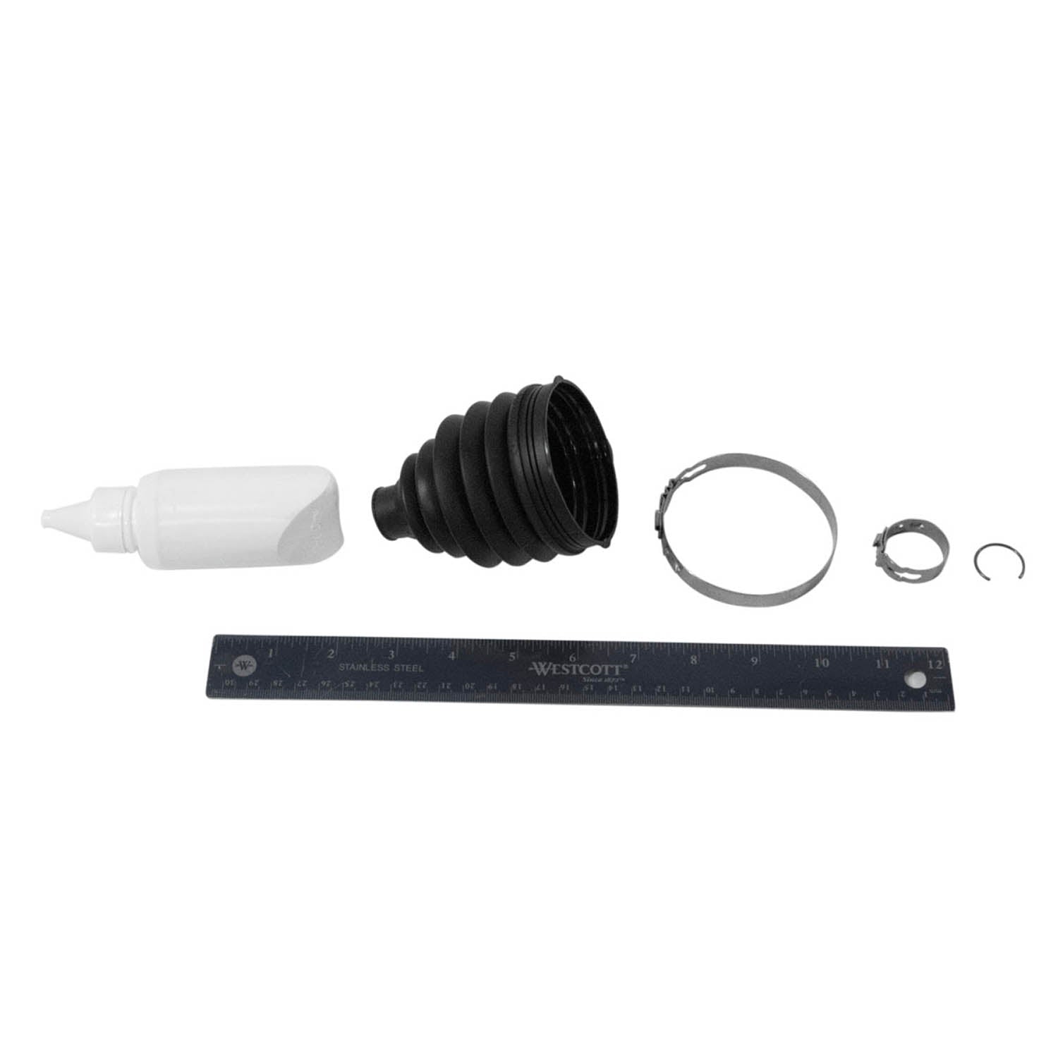 Black rubber accordion-style CV boot with silver metal clamps, white lubricant bottle, and a black ruler laid out on white.