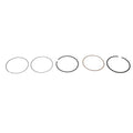 Set of five metal piston rings in varying thicknesses and colors, arranged in a row on white background.