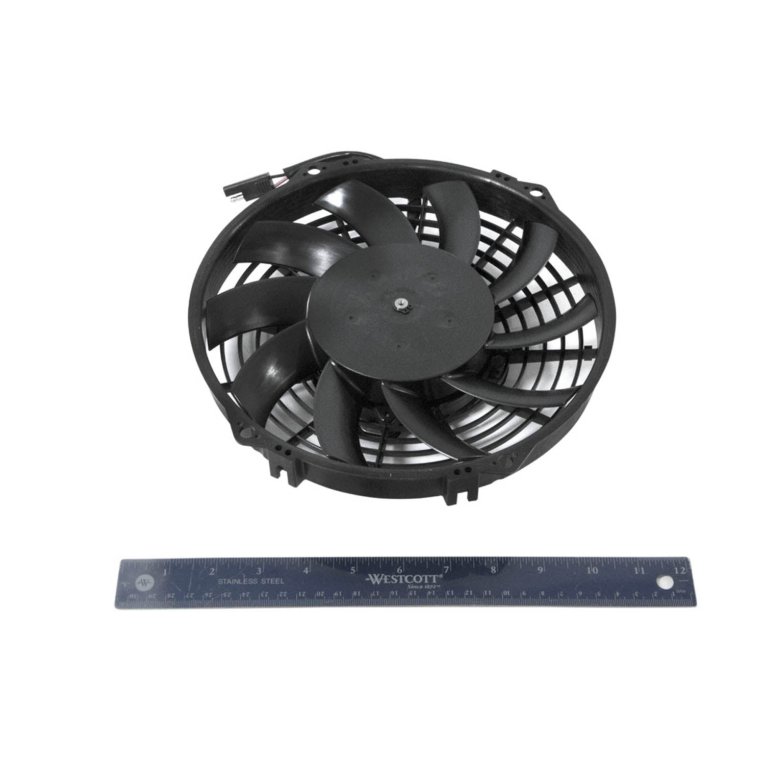 Black circular electric fan with curved blades and attached wiring, shown next to a 12-inch ruler for scale.