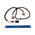Black and brown Polaris cargo box harness with connectors and black wiring next to a blue 12-inch ruler.