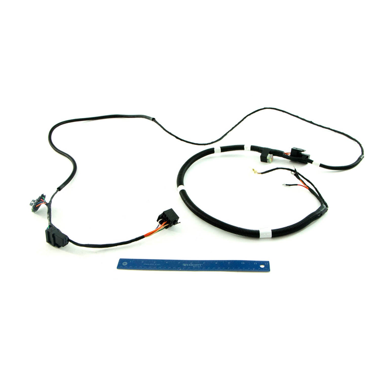 Black wiring harness with multiple connectors and clips, designed for offroad vehicle use, shown alongside a blue ruler for.