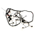 Black and red automotive wiring harness with multiple connectors and protective sheathing.