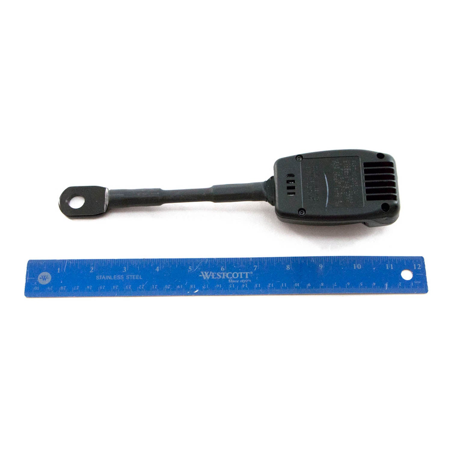 Black plastic Polaris seatbelt buckle cable with metal loop end next to a blue 12-inch ruler.