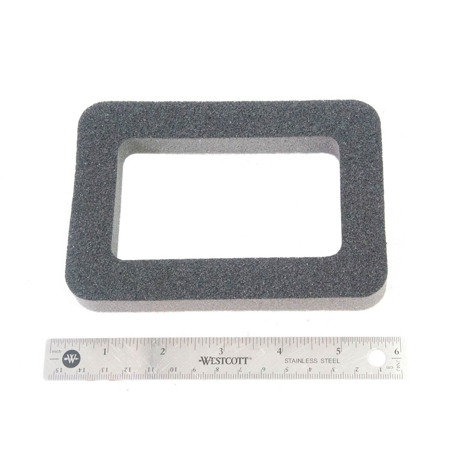 Rectangular black foam HVAC seal with a hollow center, shown beside a 6-inch ruler for scale.