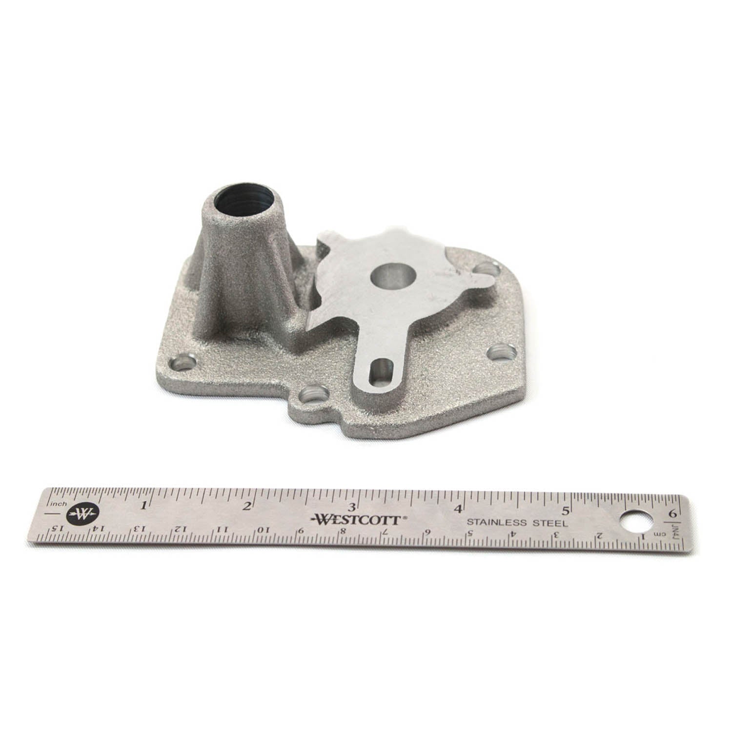 Gray metal Polaris gear sector cover with mounting holes and integrated cylindrical housing next to a 6-inch ruler for scale.