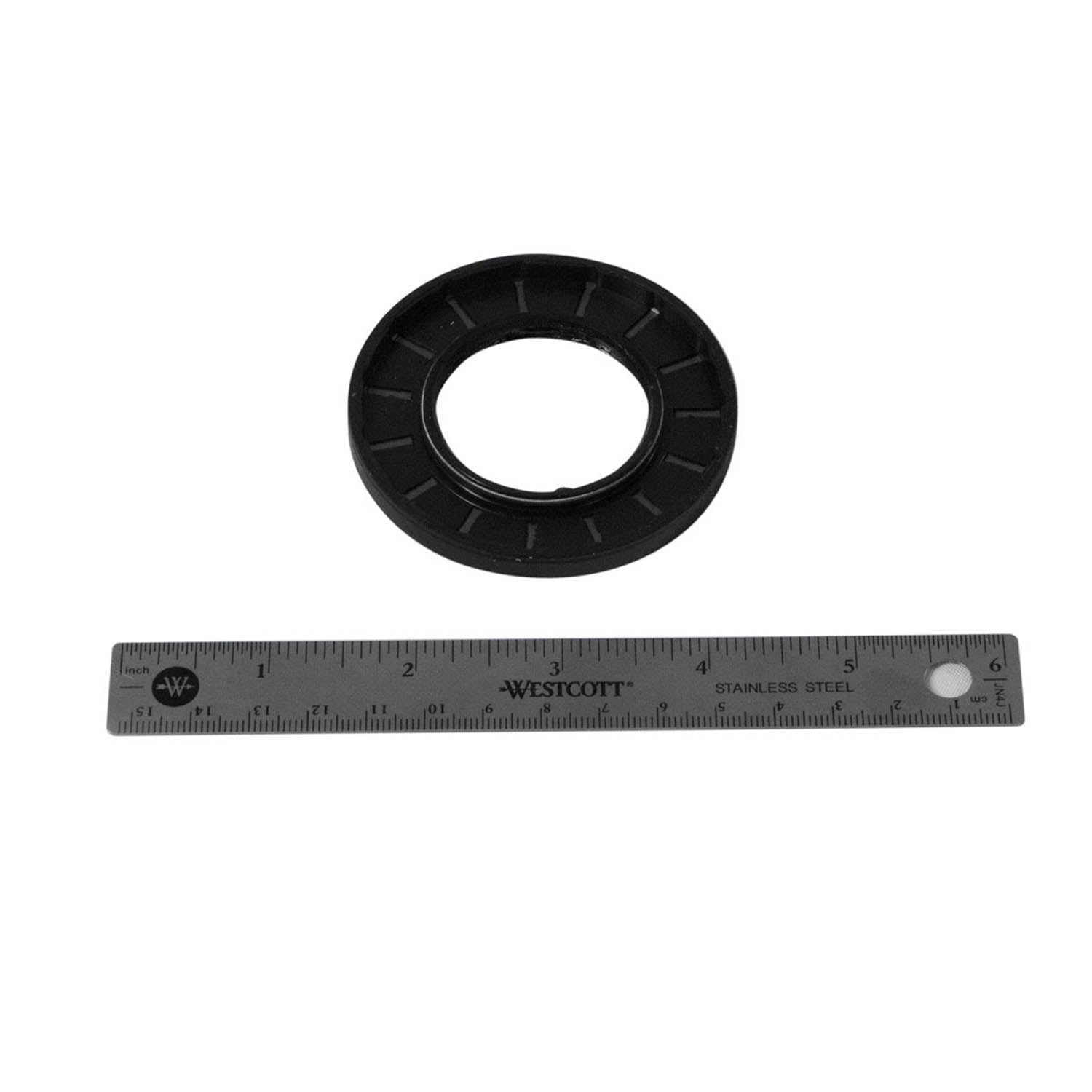 Black rubber triple lip seal with ridged outer edge next to a 12-inch metal ruler for scale.