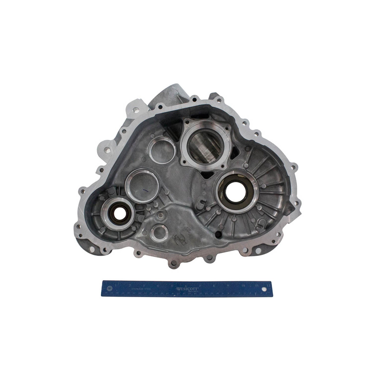 Gray metal Polaris main gearcase left side with circular openings and mounting holes, shown with blue ruler for scale.