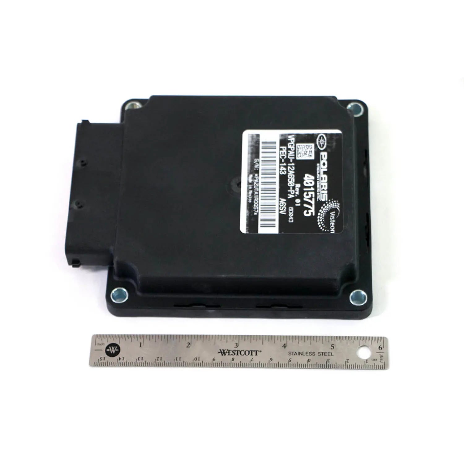Black rectangular motorcycle PCM unit with mounting holes and barcode label, placed next to a six-inch ruler for scale.