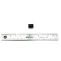 Small black cylindrical oil pump piston placed above a 12-inch silver metal ruler with black markings.