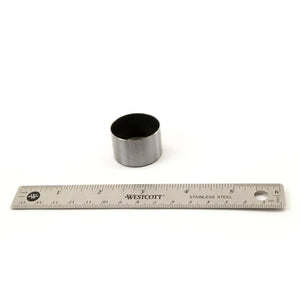 Cylindrical metal valve tappet with smooth surface next to silver metal ruler.