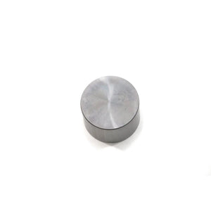 Round metallic valve tappet with smooth polished surface and flat top.