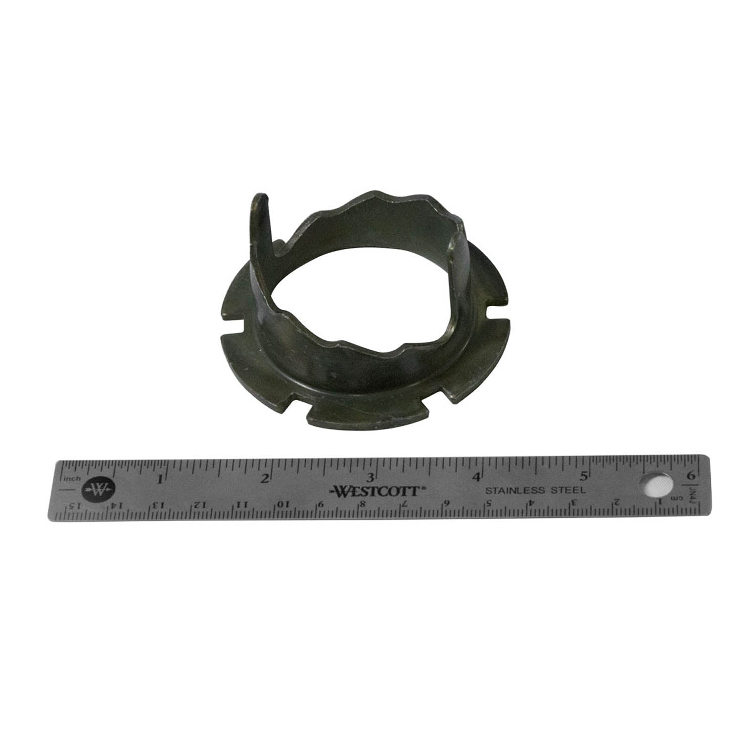 Black steel circular clamp with irregular edges and cutouts, next to a 12-inch metal ruler for scale.