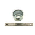 Metal cup spring boss with circular flanged top and hollow center, shown next to a 12-inch ruler for scale.