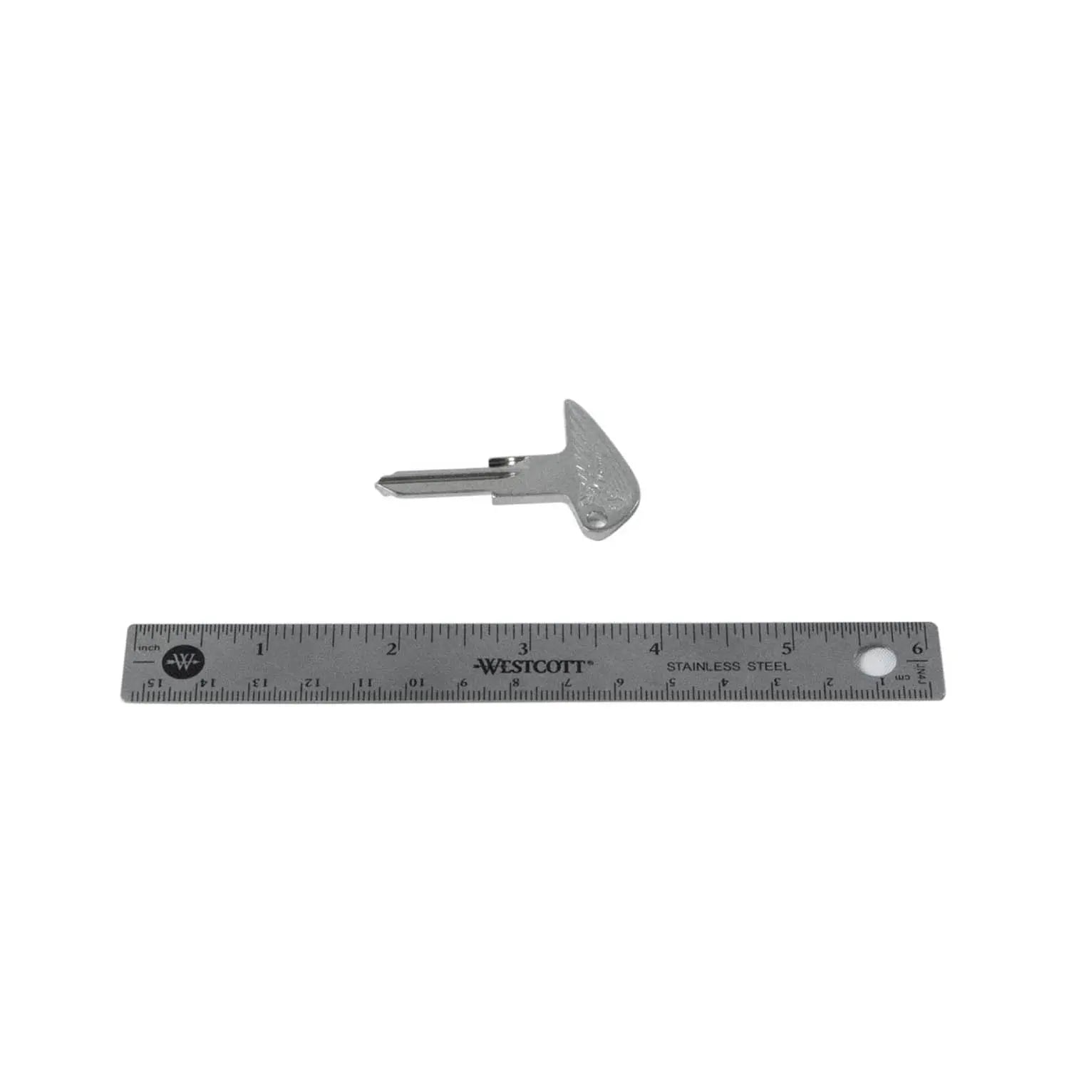 Silver metal motorcycle key blank with triangular bow and uncut blade next to a 6-inch ruler.