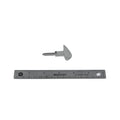 Silver metal motorcycle key blank with triangular bow and uncut blade next to a 6-inch ruler.