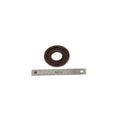 Brown rubber flange seal with circular shape and central hole, next to silver metal ruler.