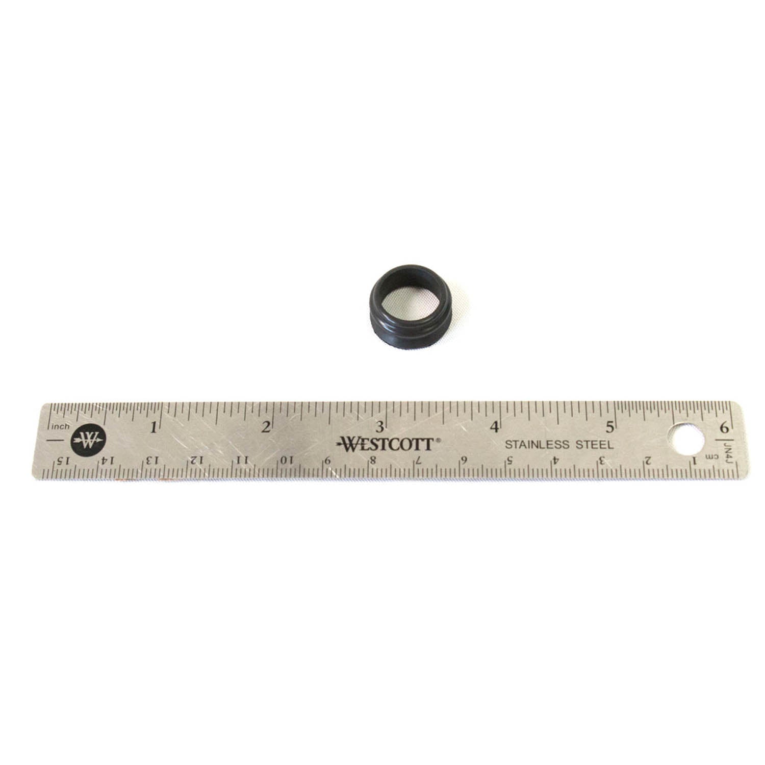 Small black rubber inlet oil seal with circular shape, next to a 12-inch stainless steel ruler for scale.