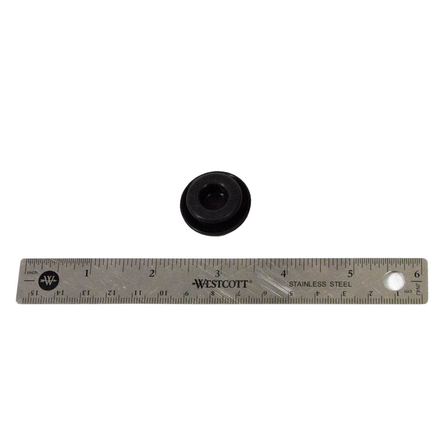 Small black rubber plug with a central hole, placed above a 6-inch stainless steel ruler.