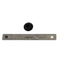 Small black rubber plug with a central hole, placed above a 6-inch stainless steel ruler.