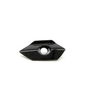 Black glossy saddlebag lock bezel with angular shape and central circular keyhole opening.