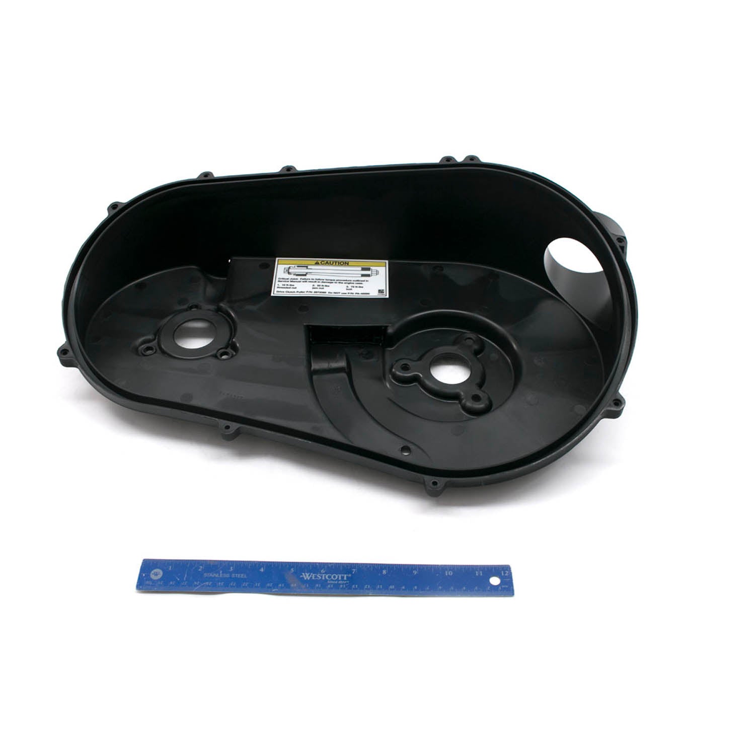 Black plastic inner clutch cover with circular mounting areas and labeled sticker inside.