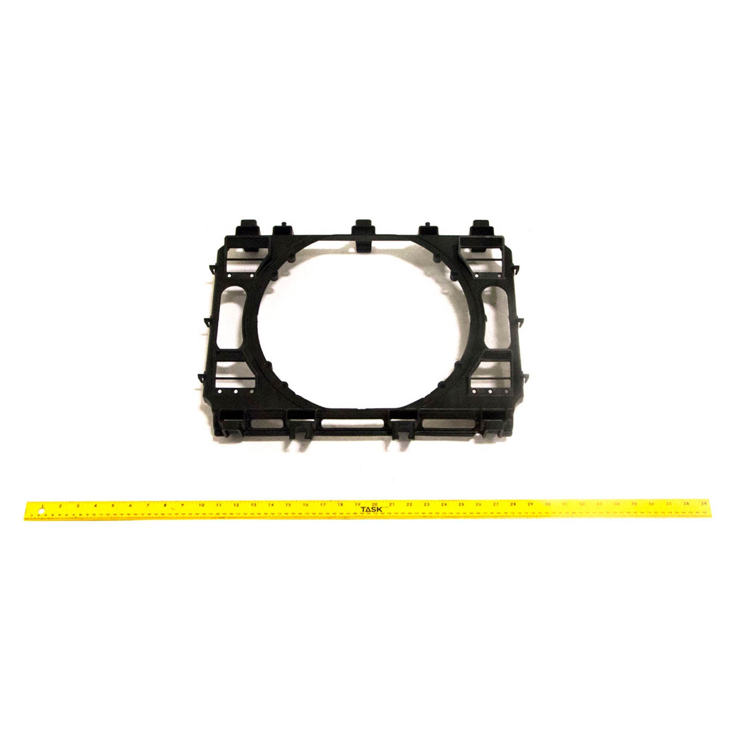 Black plastic fan shroud with a central circular opening and mounting tabs around edges.