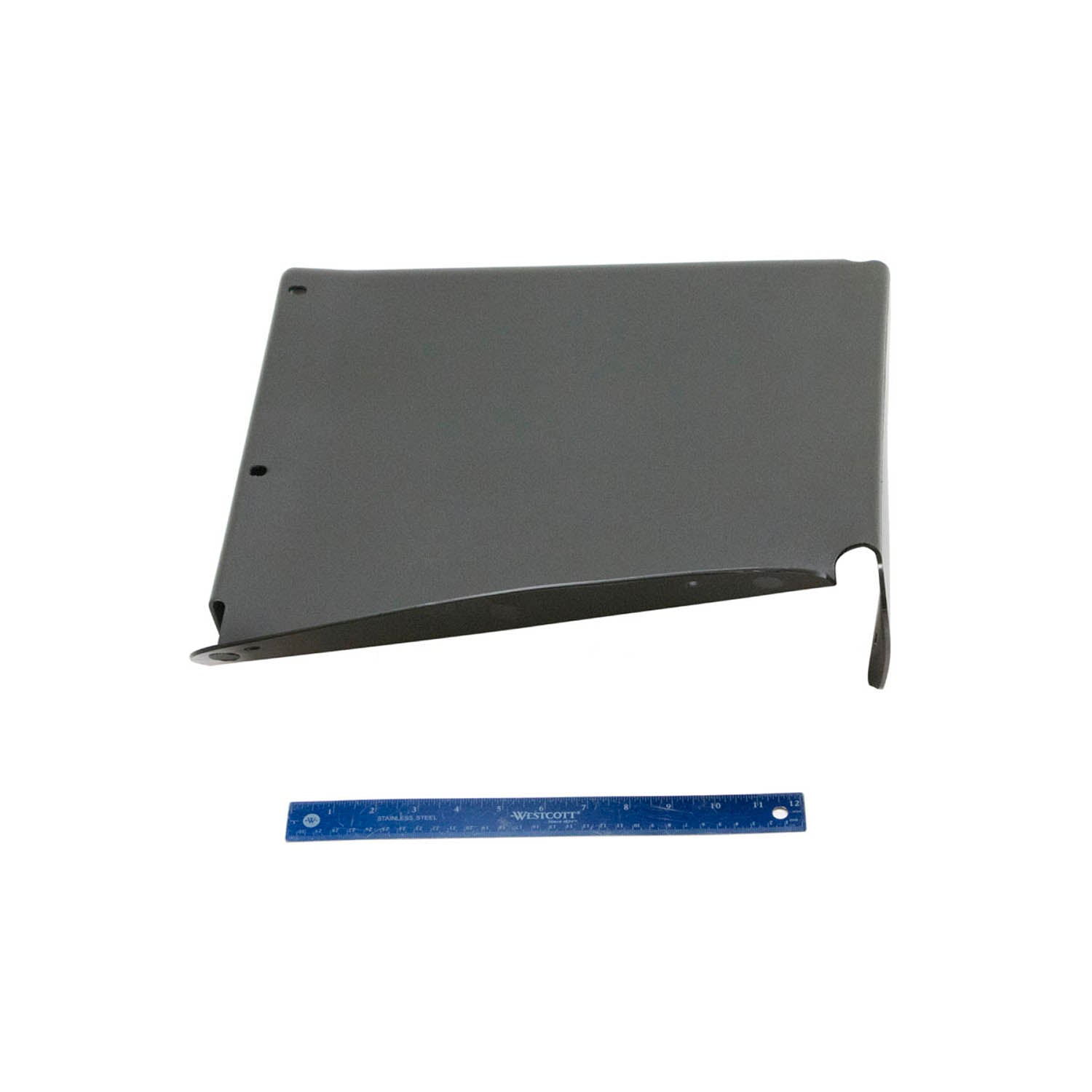 Black rear inner fender panel with smooth matte finish and mounting holes, accompanied by blue ruler for scale.