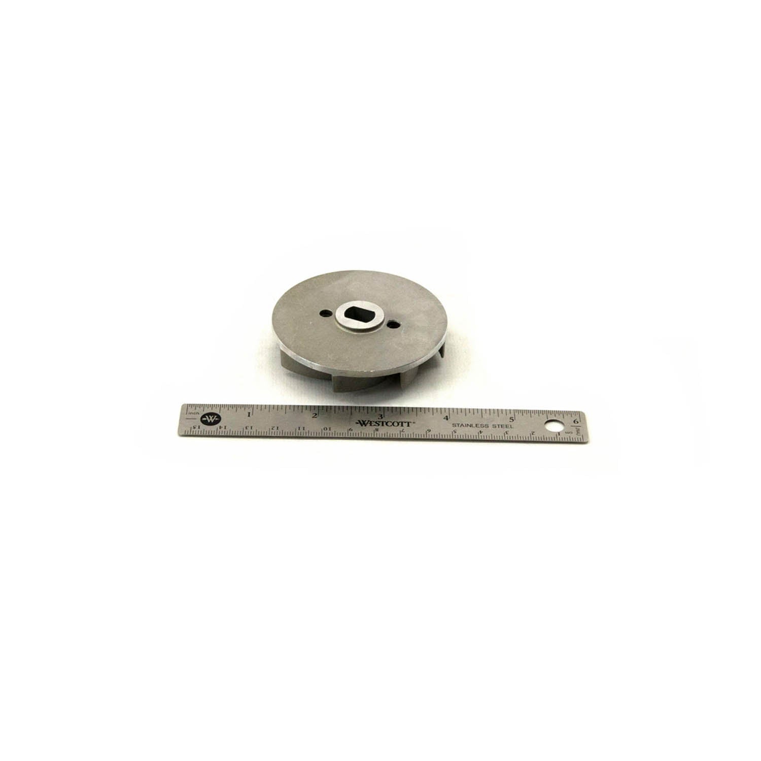 Gray metal water pump impeller with central mounting hole next to a metal ruler for scale.