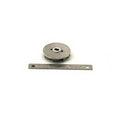 Gray metal water pump impeller with central mounting hole next to a metal ruler for scale.