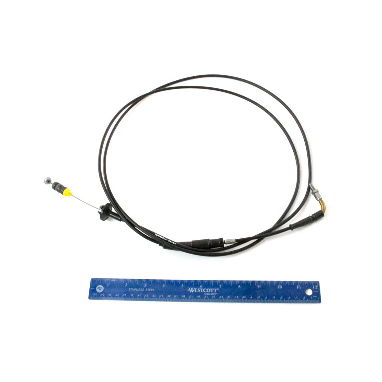 Black flexible throttle cable with metal connectors and yellow plastic tip, alongside blue 12-inch ruler for scale.