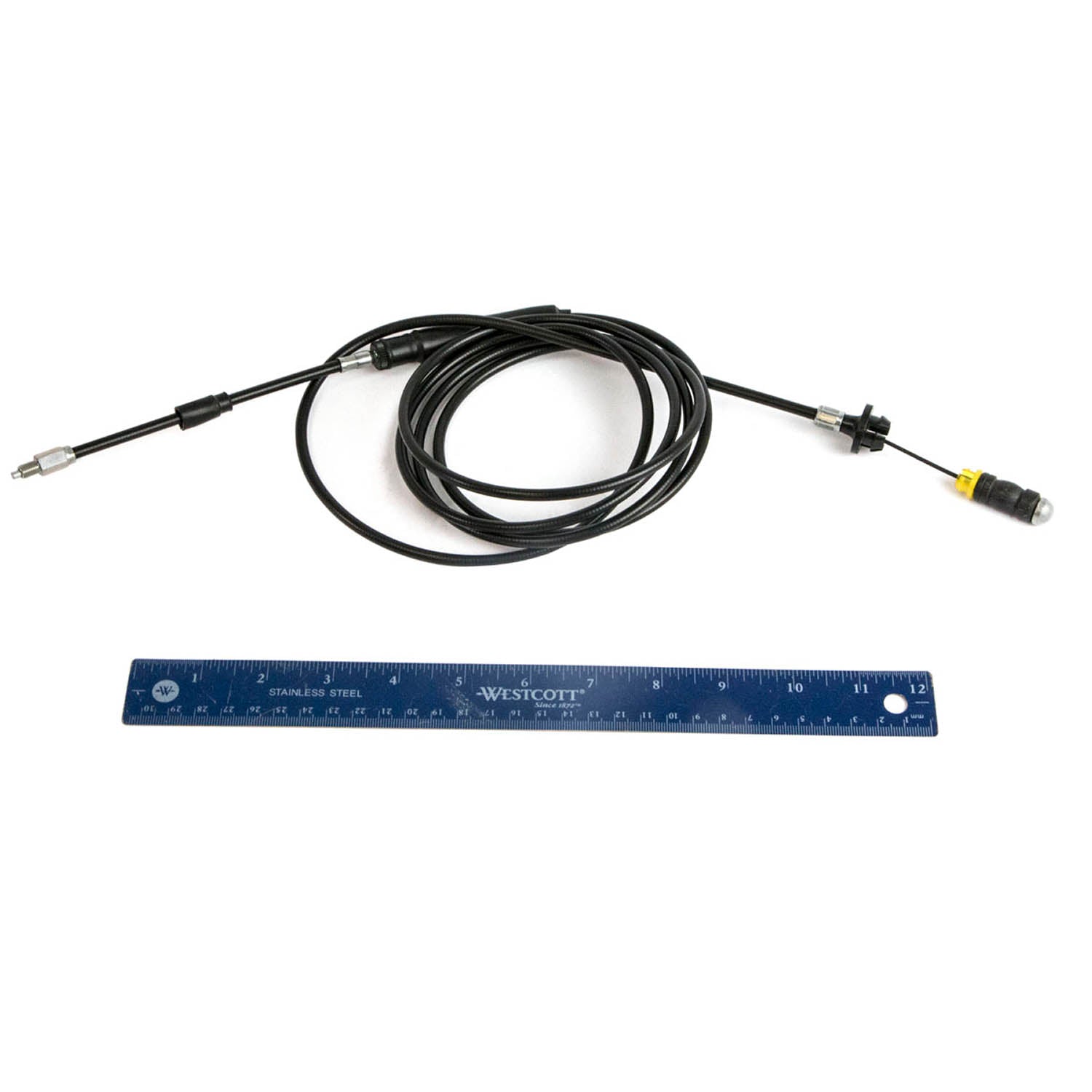 Black flexible throttle cable with metal connectors on both ends beside a blue 12-inch ruler.